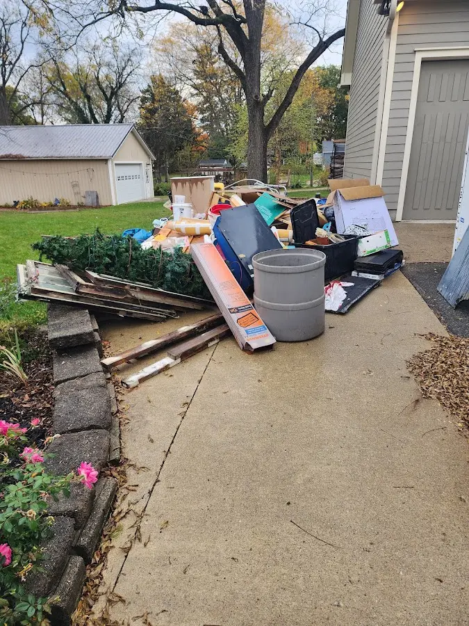 Dumpster being loaded with debris for Commercial Dumpster Rental in Hays